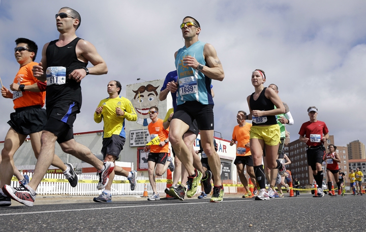 New Jersey Marathon runners pass the iconic Wonder Bar sign in Asbury Park, N.J., Sunday, May 5, 2013. The race was run only on roadways this year since most Jersey Shore boardwalks were damaged by Superstorm Sandy. (AP Photo/Mel Evans)