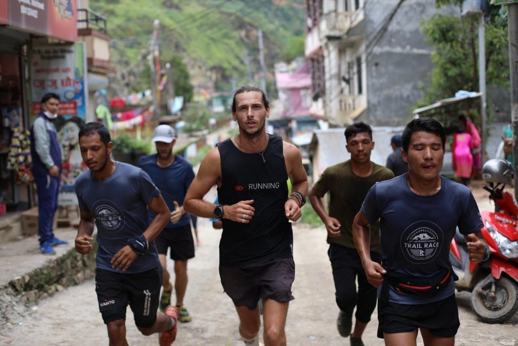 Nick running with locals in Nepal © NICK BUTTER