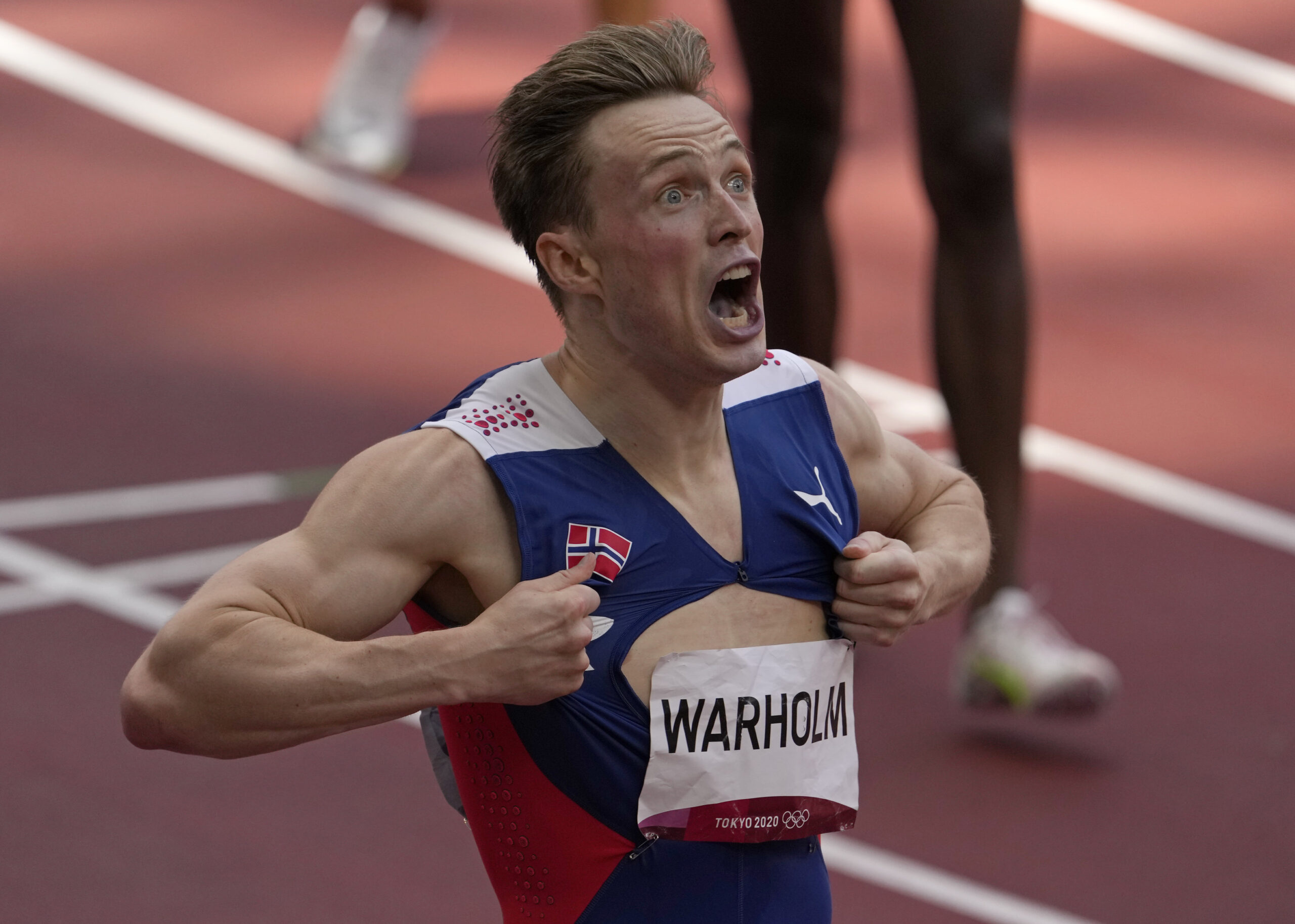 Karsten Warholm, of Norway celebrates as he wins the gold medal in the final of the men's 400-meter hurdles at the 2020 Summer Olympics, Tuesday, Aug. 3, 2021, in Tokyo, Japan. (AP Photo/Charlie Riedel)