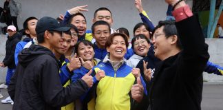 神野大地前排右三到訪桃園高中，親切地穿上桃高制服，和學生玩在一塊